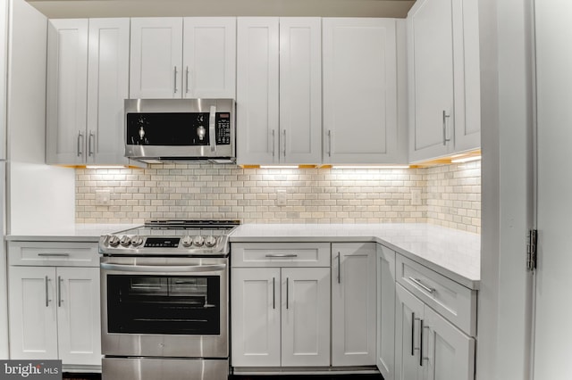 1761 Old Meadow Rd Unit 209, Mclean, VA 22102 - kitchen featuring appliances with stainless steel finishes, white cabinetry, and tasteful backsplash