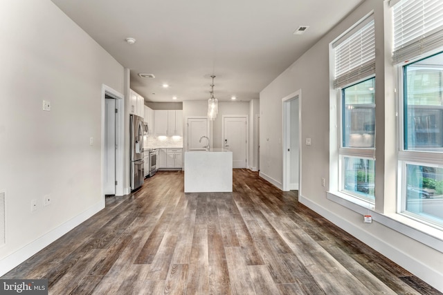 1761 Old Meadow Rd Unit 209, Mclean, VA 22102 - kitchen with stainless steel refrigerator with ice dispenser, white cabinetry, a sink, plenty of natural light, and recessed lighting