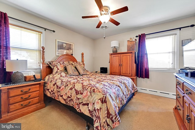 bedroom featuring baseboard heating, light colored carpet, and a ceiling fan