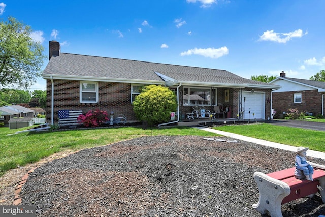 single story home with a porch, a garage, brick siding, and asphalt driveway