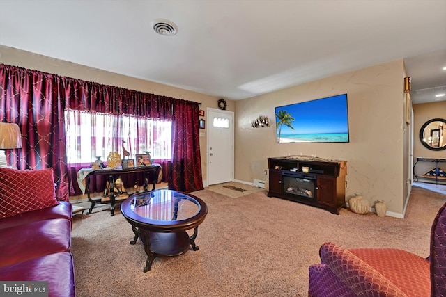 living area featuring carpet floors, baseboards, and a baseboard heating unit