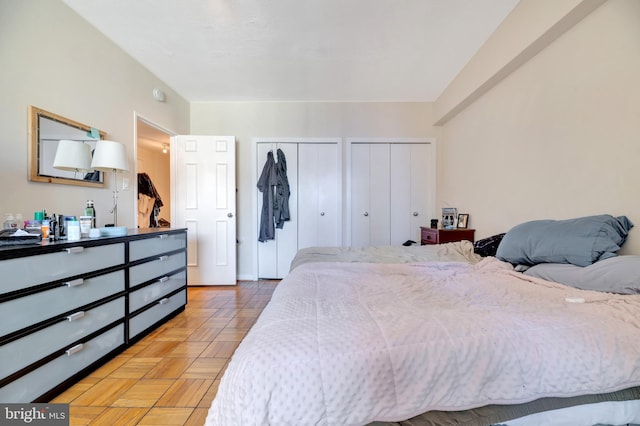 bedroom featuring multiple closets