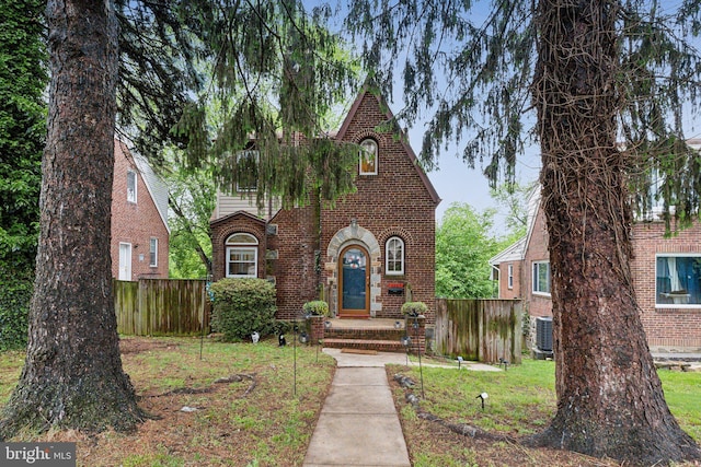 5207 Eugene Ave, Baltimore, MD 21206 - tudor home featuring brick siding, fence, and cooling unit