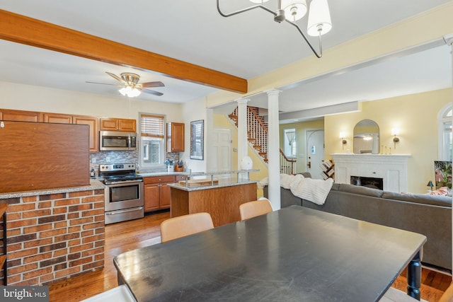 5207 Eugene Ave, Baltimore, MD 21206 - kitchen featuring stainless steel appliances, beam ceiling, light wood-style floors, a ceiling fan, and light countertops