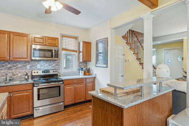 5207 Eugene Ave, Baltimore, MD 21206 - kitchen featuring stainless steel appliances, a sink, ceiling fan, and plenty of natural light