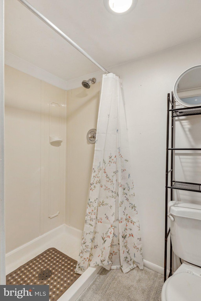 5207 Eugene Ave, Baltimore, MD 21206 - full bathroom with a shower stall, toilet, and baseboards