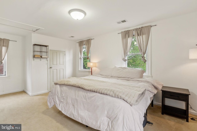 5207 Eugene Ave, Baltimore, MD 21206 - bedroom with light colored carpet, attic access, multiple windows, and baseboards