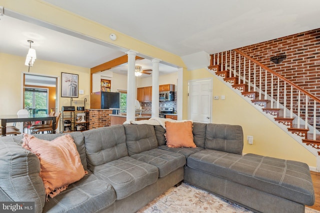5207 Eugene Ave, Baltimore, MD 21206 - living room with ornate columns, light wood-type flooring, and stairs