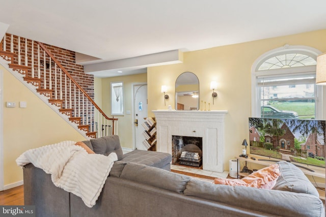 5207 Eugene Ave, Baltimore, MD 21206 - living area featuring stairs, a fireplace with flush hearth, wood finished floors, and baseboards