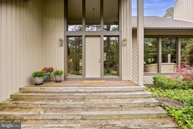 property entrance with roof with shingles