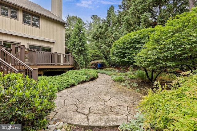 view of yard with a deck and stairway