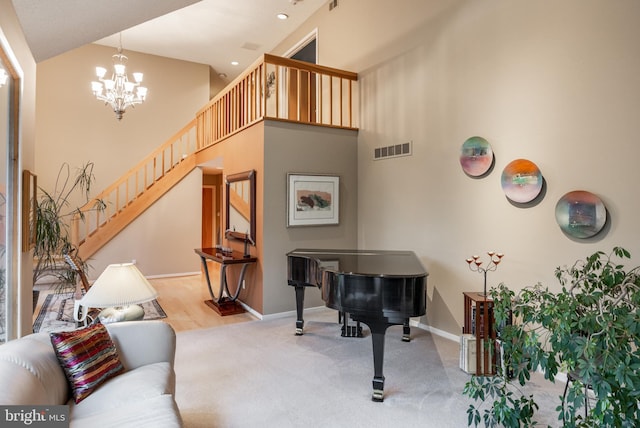 living room with a chandelier, baseboards, a high ceiling, stairway, and carpet floors