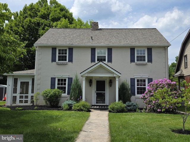 509 Haldeman Blvd, New Cumberland, PA 17070 - colonial-style house featuring a chimney, a front yard, and roof with shingles