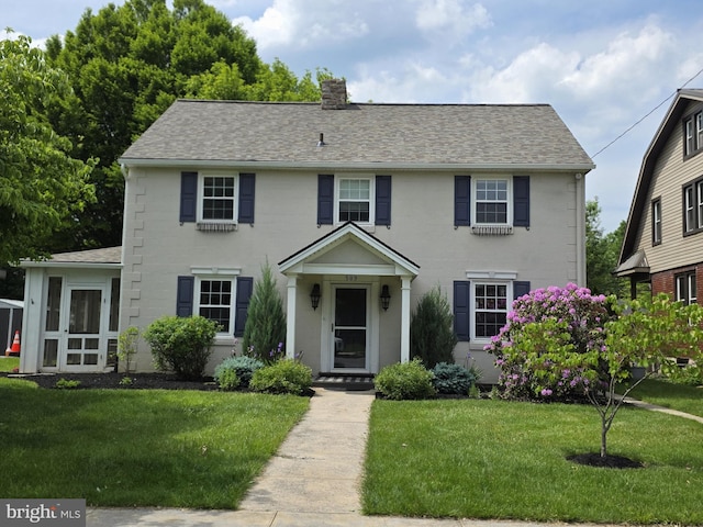 509 Haldeman Blvd, New Cumberland, PA 17070 - colonial home with a shingled roof, a front yard, and a chimney