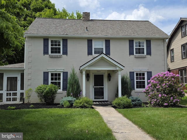 509 Haldeman Blvd, New Cumberland, PA 17070 - colonial-style house with a chimney, a front lawn, and roof with shingles