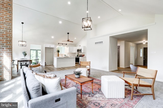1017 Mill Rd, Leesport, PA 19533 - living room with a chandelier, high vaulted ceiling, baseboards, and recessed lighting