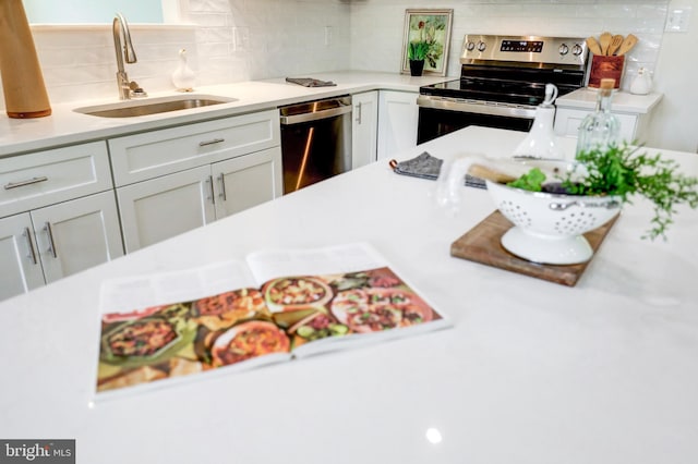 1017 Mill Rd, Leesport, PA 19533 - kitchen with stainless steel appliances, a sink, backsplash, and light countertops