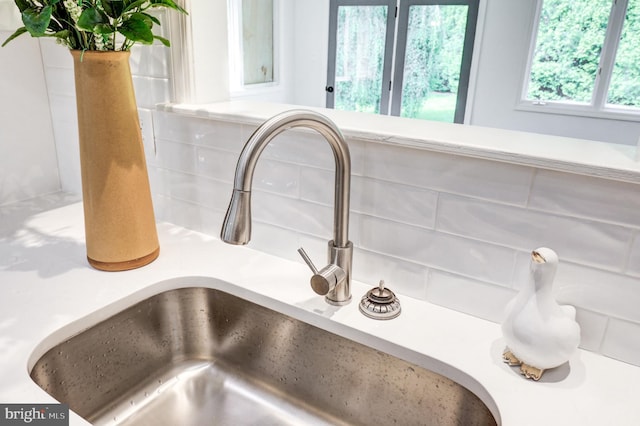 1017 Mill Rd, Leesport, PA 19533 - kitchen view of a sink, decorative backsplash, and light countertops