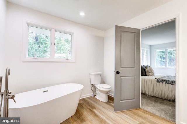 1017 Mill Rd, Leesport, PA 19533 - ensuite bathroom featuring a freestanding bath, wood finished floors, toilet, and recessed lighting