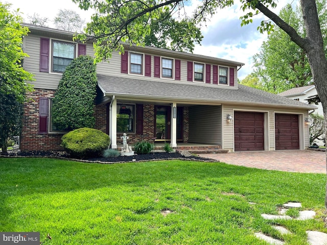 612 Howard Ave, Pitman, NJ 08071 - view of front of house with covered porch, decorative driveway, a front lawn, an attached garage, and brick siding