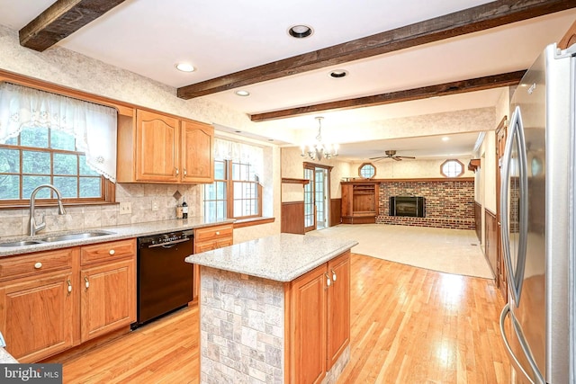 612 Howard Ave, Pitman, NJ 08071 - kitchen featuring freestanding refrigerator, dishwasher, a sink, a brick fireplace, and light wood-type flooring