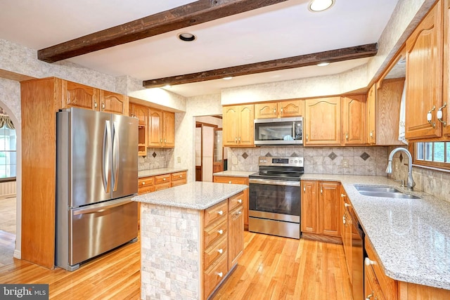 612 Howard Ave, Pitman, NJ 08071 - kitchen featuring appliances with stainless steel finishes, a sink, light wood-style floors, light stone counters, and beam ceiling