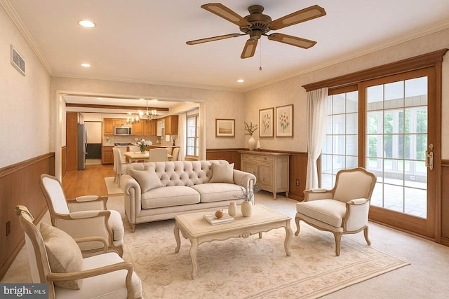 612 Howard Ave, Pitman, NJ 08071 - living room featuring a chandelier, healthy amount of natural light, wainscoting, crown molding, and a ceiling fan