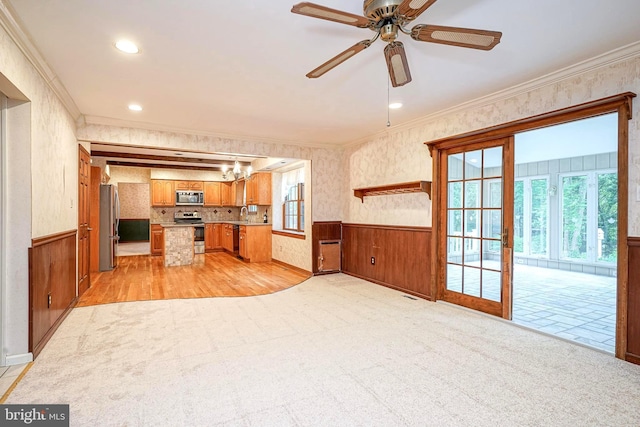 612 Howard Ave, Pitman, NJ 08071 - kitchen featuring stainless steel appliances, ornamental molding, a chandelier, wainscoting, and brown cabinetry