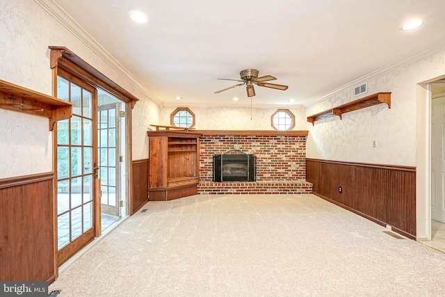 612 Howard Ave, Pitman, NJ 08071 - unfurnished living room with a ceiling fan, wainscoting, wooden walls, a fireplace, and crown molding