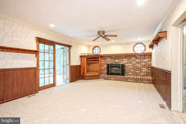 612 Howard Ave, Pitman, NJ 08071 - unfurnished living room with ceiling fan, wainscoting, a fireplace, wooden walls, and carpet floors