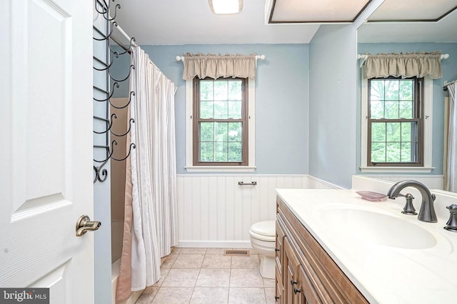 612 Howard Ave, Pitman, NJ 08071 - full bath featuring a wainscoted wall, plenty of natural light, toilet, vanity, and tile patterned flooring