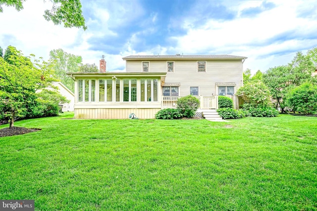 612 Howard Ave, Pitman, NJ 08071 - rear view of property with a chimney, a sunroom, and a lawn