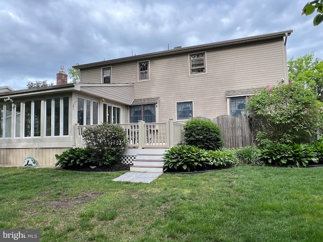 612 Howard Ave, Pitman, NJ 08071 - rear view of house with a deck, a yard, and a chimney