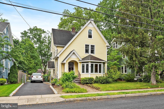 141 S St, Hightstown, NJ 08520 - view of front of property with roof with shingles, a chimney, and a front lawn