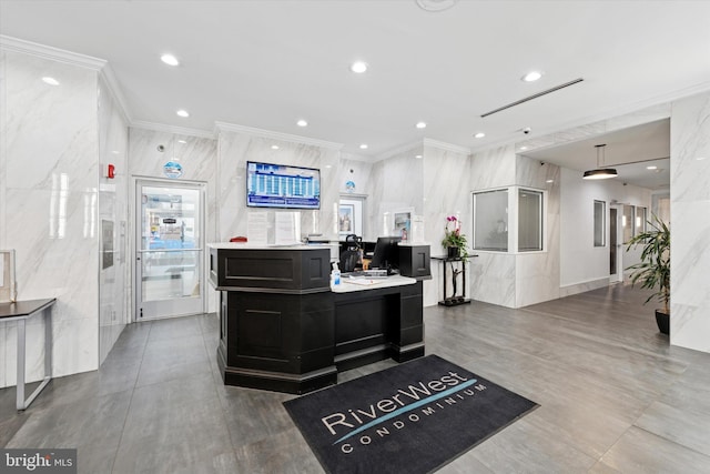 reception area with ornamental molding and recessed lighting