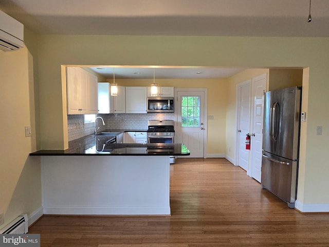 5934 Tilghman Island Rd, Tilghman, MD 21671 - kitchen featuring stainless steel appliances, a wall unit AC, a baseboard radiator, and baseboards