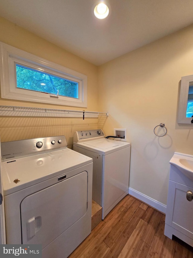 5934 Tilghman Island Rd, Tilghman, MD 21671 - laundry room with washer and clothes dryer, light wood-type flooring, and baseboards