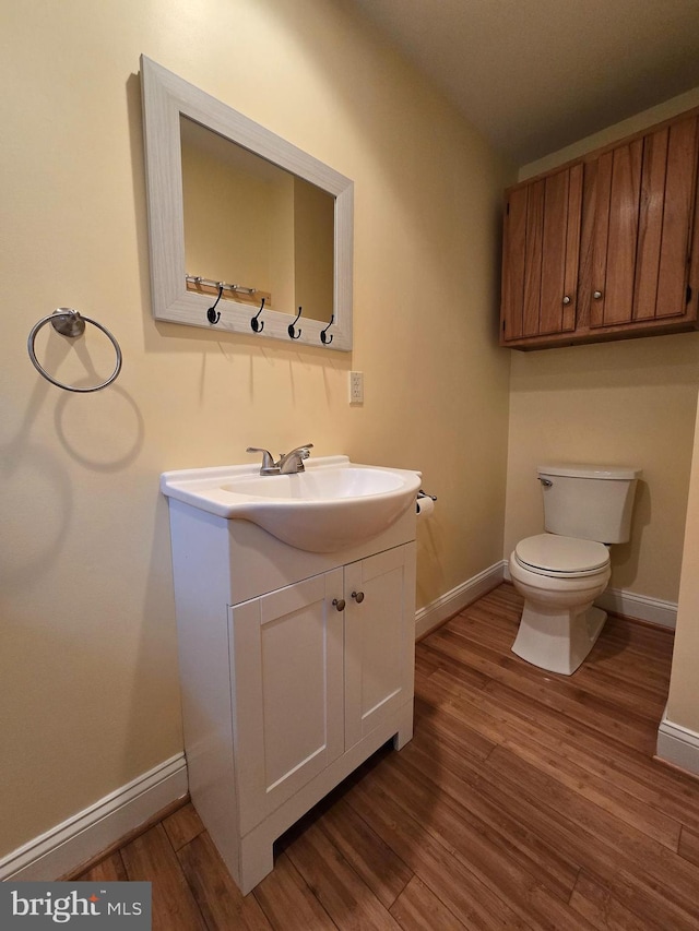 5934 Tilghman Island Rd, Tilghman, MD 21671 - bathroom with vanity, toilet, baseboards, and wood finished floors