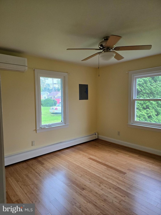 5934 Tilghman Island Rd, Tilghman, MD 21671 - unfurnished room with a wall mounted AC, a baseboard radiator, electric panel, ceiling fan, and wood finished floors