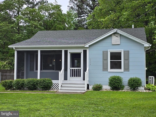 5934 Tilghman Island Rd, Tilghman, MD 21671 - bungalow-style home featuring roof with shingles, entry steps, and a sunroom