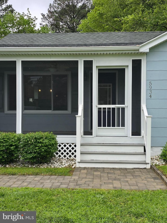 5934 Tilghman Island Rd, Tilghman, MD 21671 - view of home's exterior featuring a sunroom, entry steps, and roof with shingles