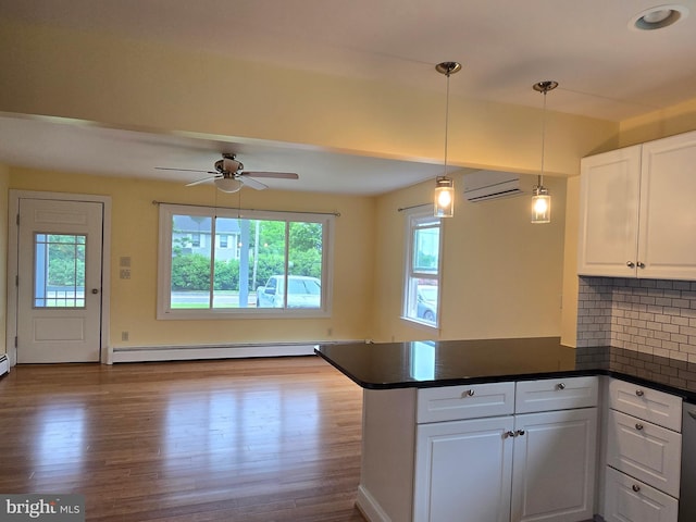 5934 Tilghman Island Rd, Tilghman, MD 21671 - kitchen featuring baseboard heating, healthy amount of natural light, a peninsula, and dark countertops