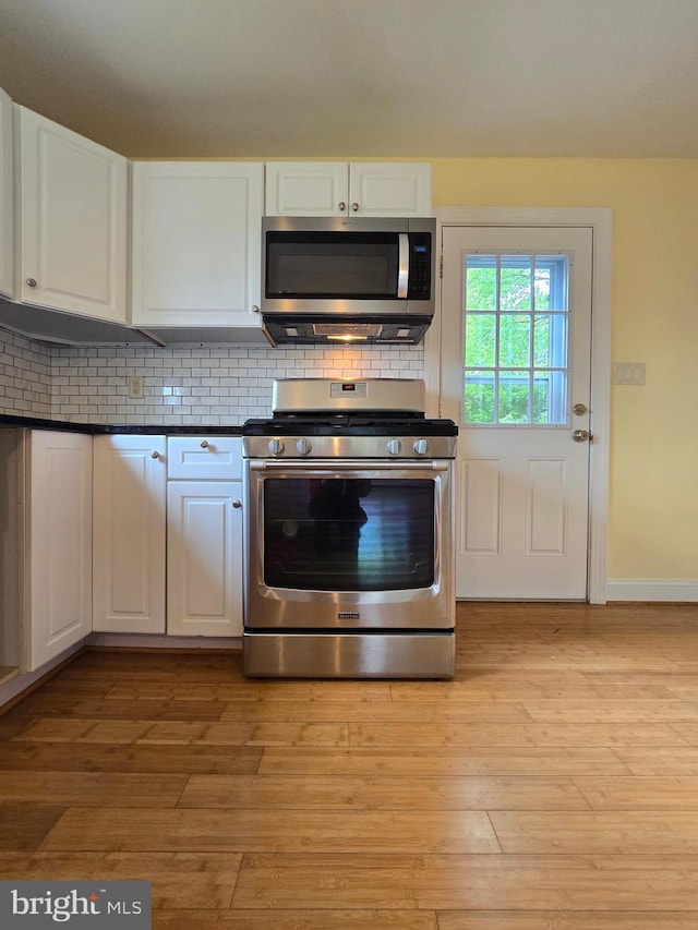 5934 Tilghman Island Rd, Tilghman, MD 21671 - kitchen with appliances with stainless steel finishes, white cabinets, and tasteful backsplash