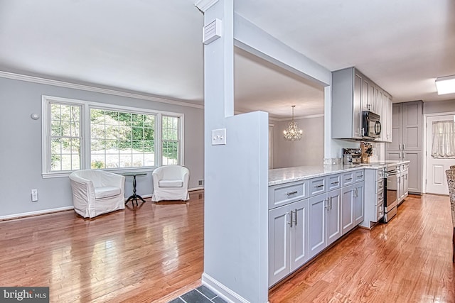 kitchen with electric stove, gray cabinets, light wood-type flooring, light stone counters, and crown molding