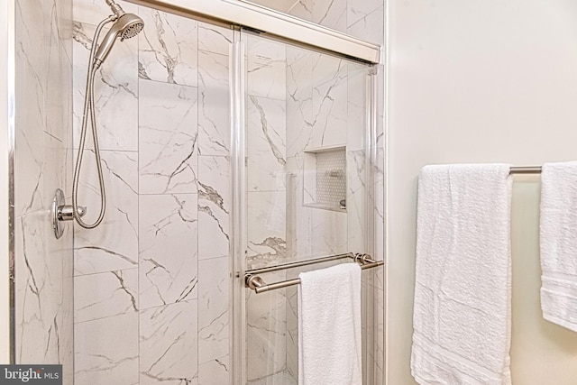 full bathroom featuring a marble finish shower