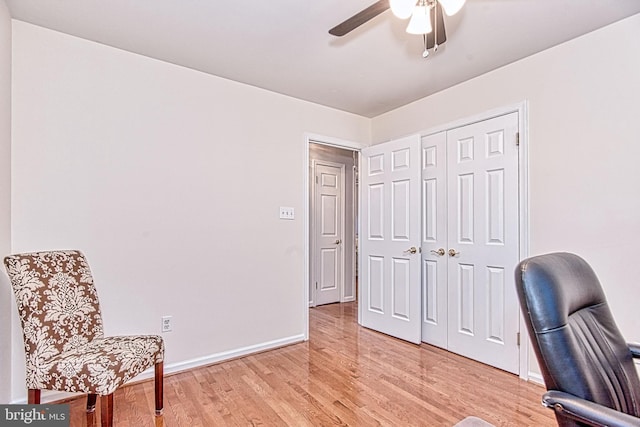 office space with ceiling fan, baseboards, and light wood finished floors