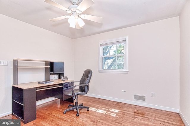 office area with light wood finished floors, baseboards, and a ceiling fan