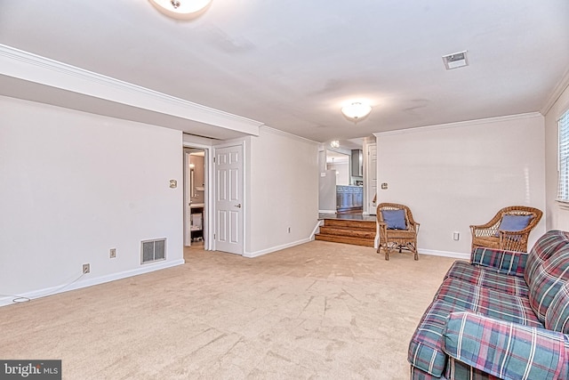sitting room with carpet floors, crown molding, and baseboards