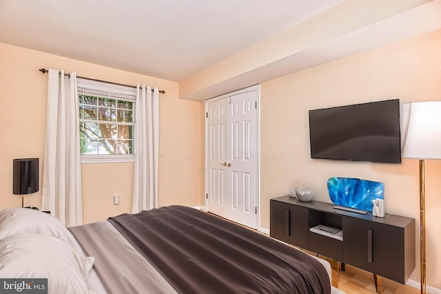 bedroom featuring a closet and wood finished floors