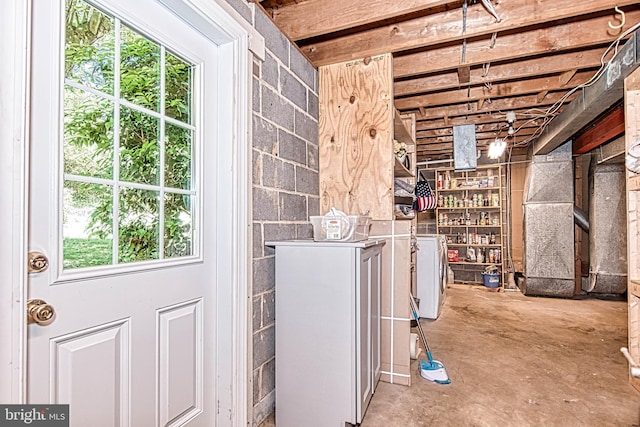 below grade area featuring plenty of natural light and washer and clothes dryer